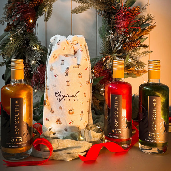 60º South Glitter Gins with and Original Spirit Co Christmas Gift Bag on green wreath