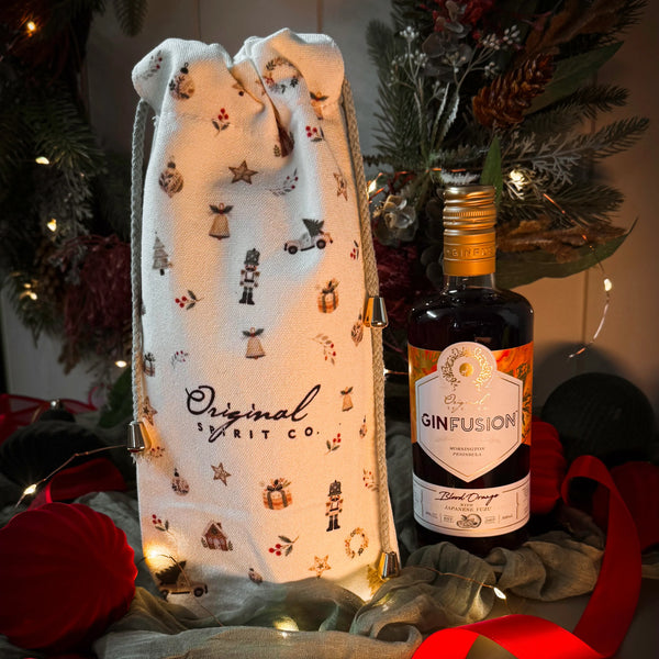 Bottle of Blood Orange Ginfusion with and Original Spirit Co Christmas Gift Bag in a festive setting