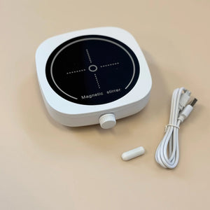 Magnetic stirrer with power cord and plug on a beige background. Made for our 60º South Australian Gin