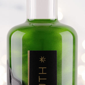 Close up of bottle of Apple & Lime 60º South Green Glitter Gin 