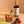 Load image into Gallery viewer, A bottle of Boozy Fruit Strawberry Vodka made into a cocktail surrounded by fresh strawberries and lime, showcasing its vibrant red hue.
